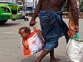 Father Carrying His Child in Bag