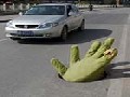 Giant Green Hand Emerges From Manhole